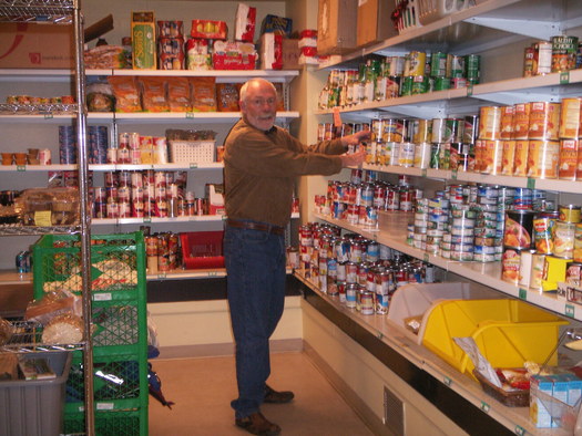 PHOTO: A volunteer stocks shelves at one of the Utah Food Bank's partner food pantries around the state. Courtesy Utah Food Bank.