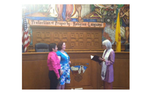 Rose Griego (L) and partner Kim Kiel being married by Reverend Hollis Walker. Photo taken by Johann Klaassen.