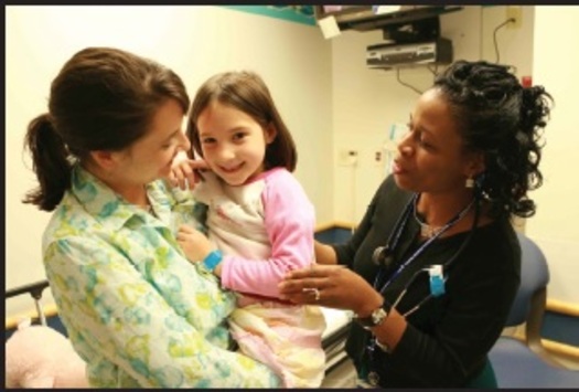 PHOTO:An Ohio facility is paving the way in finding the right balance between medical and psychiatric care to help treat young children. Photo: child with mom and doctor. Courtesy of Cincinnati Children's.