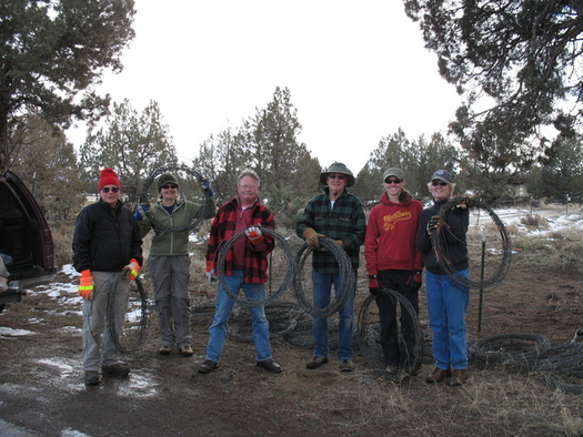 PHOTO: Hauling away old barbed-wire fence materials is harder without the use of motorized vehicles, but the 