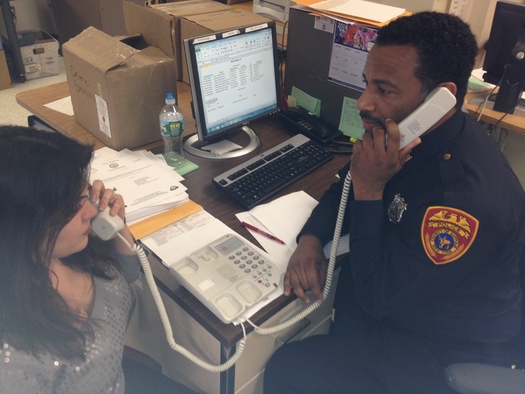 Photo: Suffolk County  P.O. Damon Barney utilizing a dual handset language line phone for interpretation exchange. Just one of the measure both police and immigrant advocates see as progress. Credit: Suffolk County P.D. 