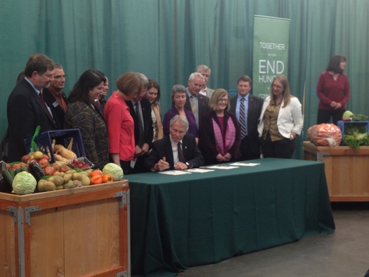 PHOTO: Fresh food and farmers were on hand, along with representatives of the Oregon Food Bank, when Gov. John Kitzhaber signed legislation on Thursday reinstating and increasing the Crop Donation Tax Credit. Photo credit: Kara Walker, Office of Oregon House Republicans.