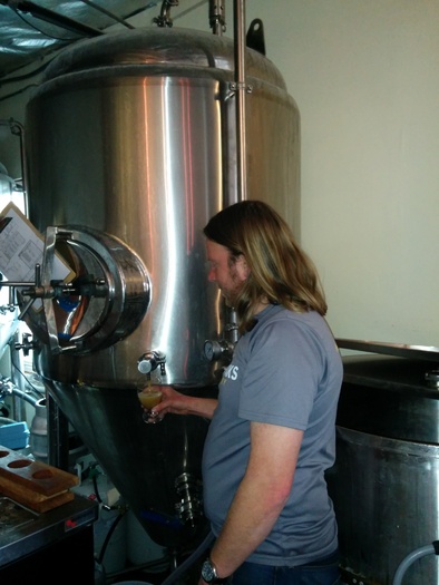 PHOTO: Brewer Kevin Klein tests the wares during the beer-making process. Since water is beer's chief ingredient, water quality is a critical factor. Photo courtesy NW Peaks Brewery. 