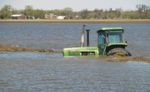 PHOTO: More frequent severe weather extremes are a concern for rural residents across the Midwest, as witnessed by this abandoned tractor during flooding last year in North Dakota. Photo courtesy U.S. Department of Agriculture.