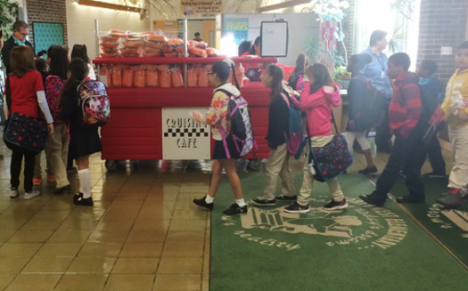PHOTO: Elementary school students in Reading stop by kiosks parked near school entrances to get free, nutritious breakfast items to eat in their classrooms. Photo courtesy Food Research and Action Center.