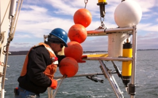 PHOTO: A University of Connecticut researcher places equipment in Long Island Sound to measure temperature, sea level pressure and waves to create maps which will predict coastal flooding. Photo credit: Mary M. Howard-Strobel.