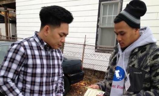 PHOTO: A canvasser from the Cambodian Mutual Assistance Association talks to a resident about open enrollment and his health care options in Lowell, MA as part of Health Care For Alls campaign Apply Now, Stay Covered Photo courtesy Cambodian Mutual Assistance Association.