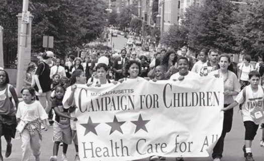 Health Care For All's 1996 victory march after state lawmakers passed legislation creating MassHealth and expanded coverage for kids. The group's 30th anniversary will be celebrated tonight in Boston. Courtesy: Health Care for All.