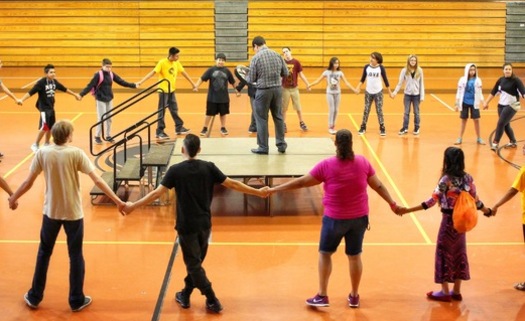 PHOTO: Program director Nation Wright leads a traditional Native American round dance with students at Minnesota's American Indian Freedom Schools program, the first of its kind among the more than 200 Freedom Schools sites across the United States. Photo courtesy of CDF-Minnesota.