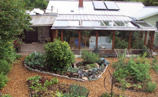 This backyard includes edible landscaping, a passive solar retrofit and a 6,500-gallon rainwater catchment system. In 2000, it was a conventional lawn. Credit: Northwest Permaculture Convergence.