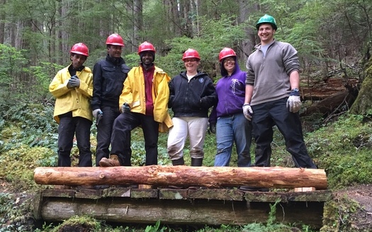 Members of the Pacific Northwest National Scenic Trail Association show off their handiwork, built to go over the Dungeness River in Olympic National Forest. Courtesy: U.S. Forest Service