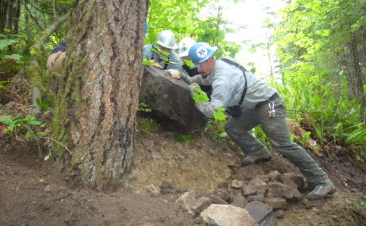 Not all National Public Lands Day projects require as much muscle as this one. Here, the Greater Oakridge Area Trail Stewards (GOATS) work on a rock retaining wall on the Willamette National Forest. Courtesy: U.S. Forest Service