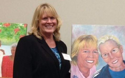 Nancy Madsen-Wilkerson, Utah's 2015 Portrait of Care honoree, with a painting of her and her mother. Credit: AARP Utah