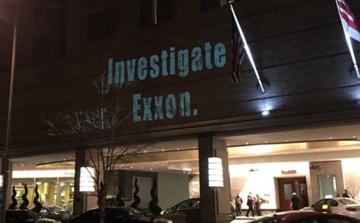 Environmentalist projected images onto the site of the NAAG meeting in Washington. (350.org)