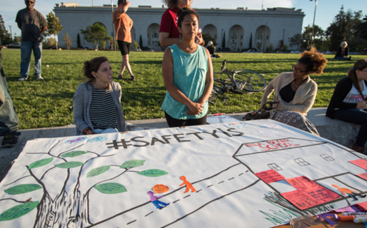 Attendees show their support at the Night Out For Safety and Liberation in Oakland, Calif., in 2015, a rival event to the National Night Out. (Brooke Anderson)
