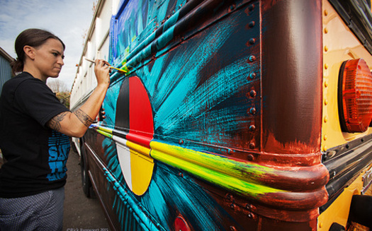 Native American artist Clay with the Native American Youth and Family Center provides a mural for a side of the Bunk Bus. (Rick Rappaport)