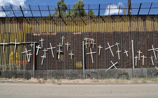 Crosses on the border fence with Mexico honor people's lives lost crossing into the United States. (Jonathan McIntosh/Creative Commons/Flickr)