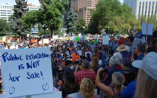 Hundreds gathered at the Colorado State Capitol to protest U.S. Secretary of Education Betsy DeVos' appearance at last week's American Legislative Exchange Council meeting. (Caroline Fry)