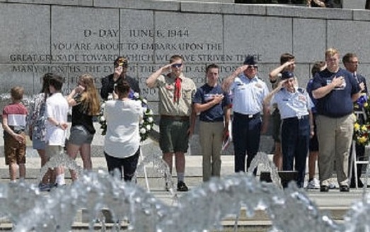 A group of military veterans and their families attend ceremonies at the World War II Memorial in Washington, D.C. (Somoderville./Getty Images
