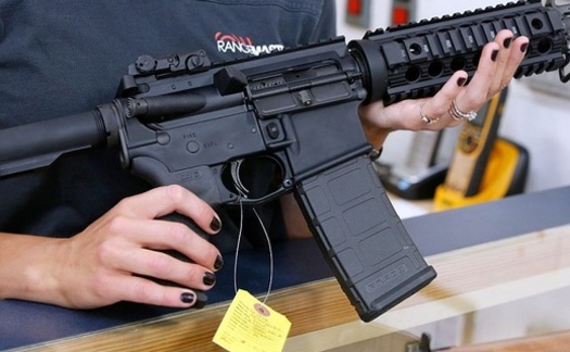 A customer examines an AR-15 semi-automatic rifle recently in a gun store. (Frey/GettyImages)