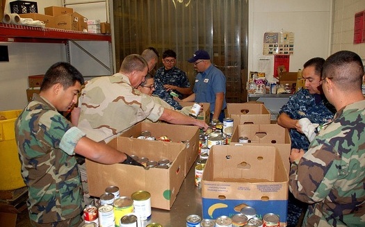 Military and civilian volunteers help sort and distribute food at the West Texas Food Bank in El Paso, one of 21 regional food banks across the state. (WikimediaCommons)<br /><br />