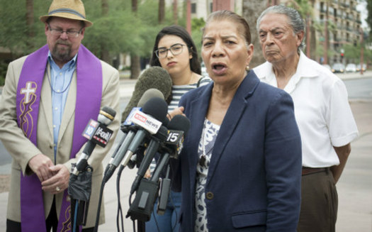 Petra Falcon gathered with community members and religious leaders Friday in front of the Immigration and Customs Enforcement Office in Phoenix to speak out against the separation of migrant children from their families. (Katherine Davis-Young/PNS)