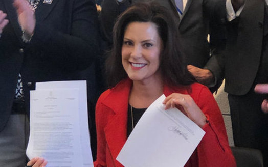 Gov. Gretchen Whitmer displays the LGBTQ anti-discrimination executive directive after a signing ceremony on Monday. (Jim Murray/Equality MI)