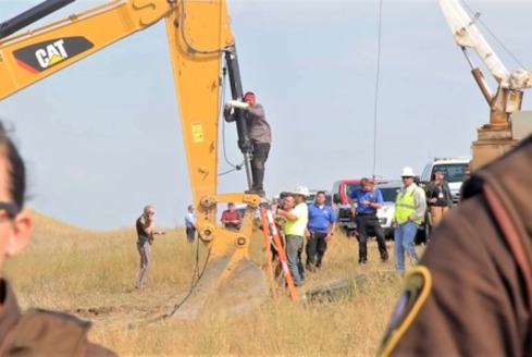 A Lakota man locks himself to construction equipment in 2016 to protest construction of the Dakota Access Pipeline. (en.wikipedia.org) 
