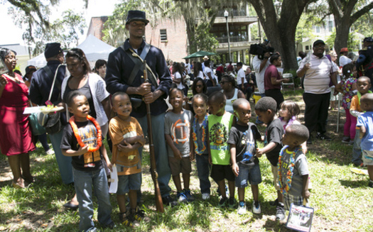 Union soldier re-enactor poses with children during Florida's Emancipation Day Celebration on May 20, 2015, at the Knott House Museum in Tallahassee. (Florida Memory)