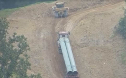 The Mountain Valley Pipeline is being built on slopes so steep that trucks carrying pipe sections sometimes have to be pulled up by bulldozers. (Alan Moore/Virginians Against Pipelines/Facebook)