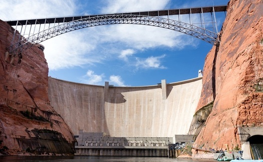The Glen Canyon Dam towers 710 feet above the original Colorado River channel, producing hydroelectric power and impounding Lake Powell as a water storage reservoir. (Jason/Adobe Stock) 