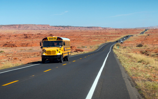 A school bus transports students through the Navajo Nation on U.S. Highway 89 in northern Arizona. Bus routes in rural school districts often cover more than 100 miles a day picking up and dropping off students. (Savola/Adobe Stock)
