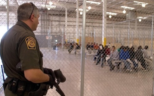 A U.S. Border Patrol agent guards migrants at one of several detention centers along the U.S.-Mexico border. (US Border Patrol and Immigration)