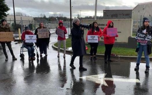 Protesters line up on Friday outside an immigrant holding station in Ferndale, Wash., where they believe a man brutally handled by ICE was being held. (Community to Community Development)
