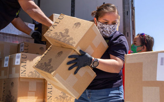 Volunteers unload boxes of water on the Navajo Nation as part of a grassroots food-distribution effort to help the 180,000 tribal members during the coronavirus pandemic. (Deidra Peaches)