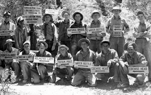 Civilian Conservation Corps workers display the handmade signs they created to post along a newly constructed trail system in 1937 at the Chiricahua National Monument in Arizona. (University of Arizona Library)