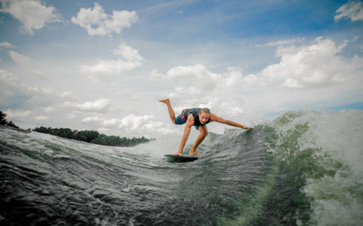 Wakesurfing requires a large wake behind a boat. A study is underway to determine the possible impact of those big waves, and other recreational boating, on lake and shoreline health in Minnesota.  (Adobe Stock)