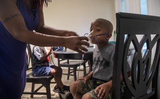 Four-year-old Jeremiah Galbreath receives a nebulizer treatment for asthma at his home in Bayboro.  (Travis Long)