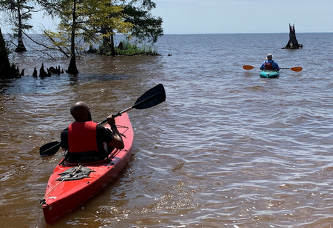 Bertie County Manager Juan Vaughan II and retired county manager Scott Sauer take to the water during the Bertie Beach grand opening in June 2019. (Sarah Tinkham/TGOW)<br />