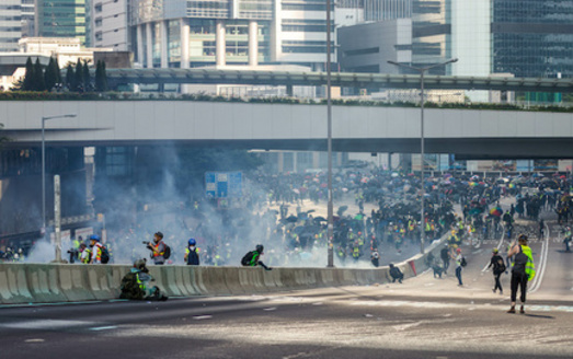 Protestors clash with police on a highway in Hong Kong. (Adobe Stock)