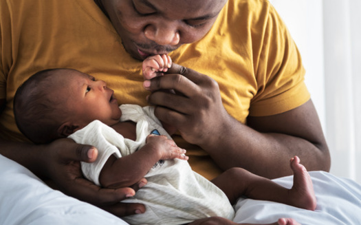 New dads - and moms - have a lot to consider when it comes to financial wellness for their families. (Anatta_Tan/Adobe Stock)