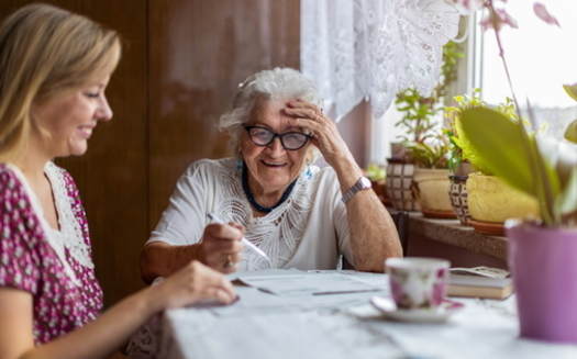 Family caregivers are spending, on average, 26% of their income on caregiving activities, according to an AARP report. (Adobe stock)