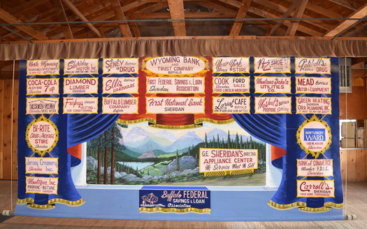 Advertising curtains, such as this one inside Kearney Community Hall, are common in community halls as stage backdrops, and were used to raise funds through local businesses paying to have ads. (Andrea Graham/Alliance for Historic Wyoming)