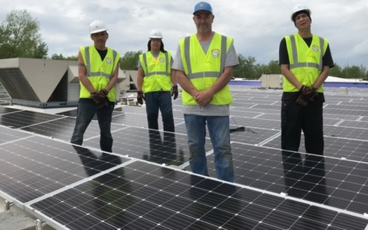 The Solar Bear crew, comprised of tribal members from the Red Lake Nation, works to install 200 kilowatts of solar power on the Oshkimiijiitahdah building. (Photo courtesy of Robert Blake)