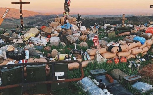 Marines carry personal items to the top of a hillside near Camp Pendleton in California, contributing to the living memorial. (Katrina Finkelstein)<br />