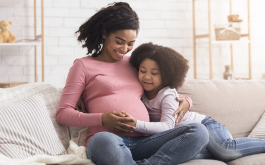 Healthcare advocacy groups say increasing Medicaid postpartum coverage up to one year after a child's birth can help decrease maternal mortality rates, which disproportionately affect people of color. (Adobe Stock)
