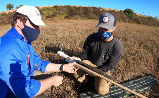 Dr. Matt Costa from Scripps Institution of Oceanography, and intern Austin Lupo with WILDCOAST, collect soil samples at Brigantine Basin in Del Mar, Calif., to measure the stored carbon. (WILDCOAST) 