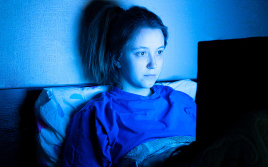 The harms from the blue light of screens is a particular concern for children and teens. (Yekatseryna/Adobe Stock)