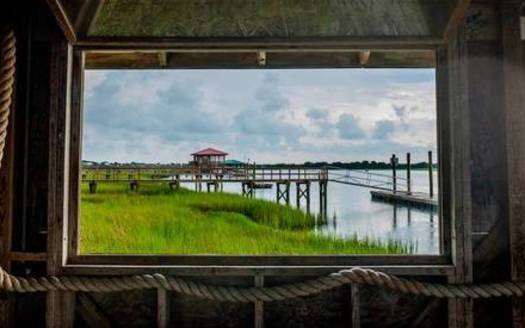 Open windows in the dock house at Bowen's Island look out on the Folly River and surrounding marsh, on Aug. 11, 2021. (Jason Lee)