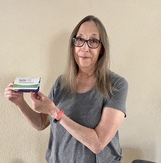 Martha Neff of Las Vegas holds a sample of a migraine medication that helps reduce pain, but costs $1,000 a month without insurance. (Courtesy of Neff Family)